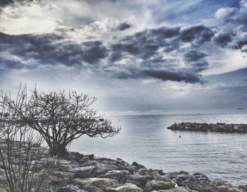 Scenic view of sea against cloudy sky