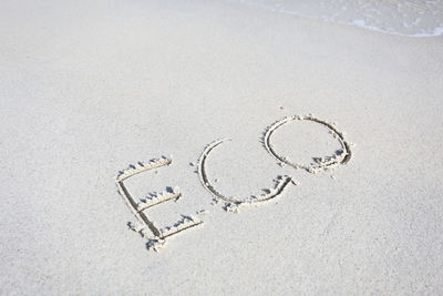 High angle view of text on sand at beach