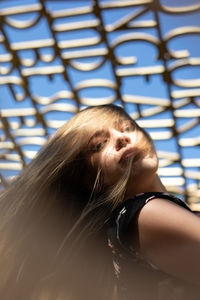 Portrait of young woman sitting outdoors