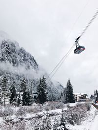 Overhead cable car against sky during winter