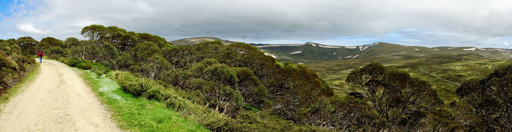 Panoramic shot of road by mountains against sky