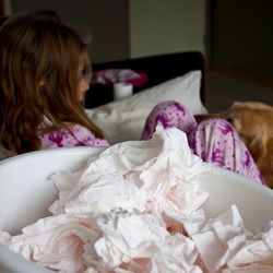 Tissues by girl lying in bedroom