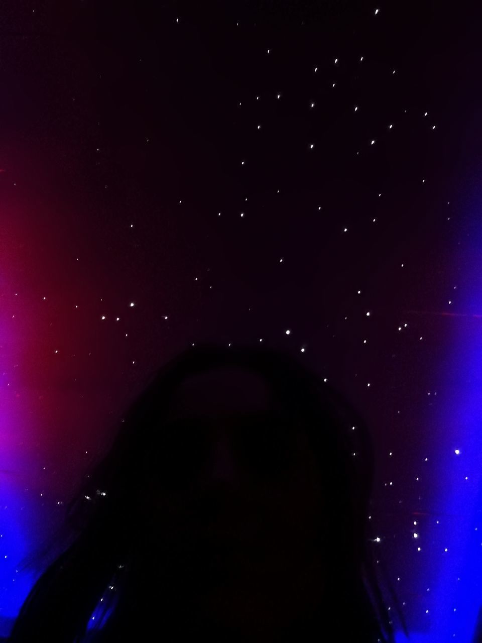 CLOSE-UP OF WOMAN AGAINST STAR FIELD