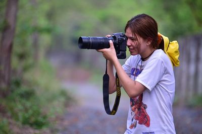 Side view of woman photographing