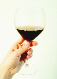 Close-up of cropped hand holding wineglass
