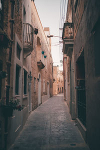 Narrow alley amidst buildings in city