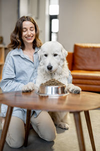 Portrait of smiling young woman with dog