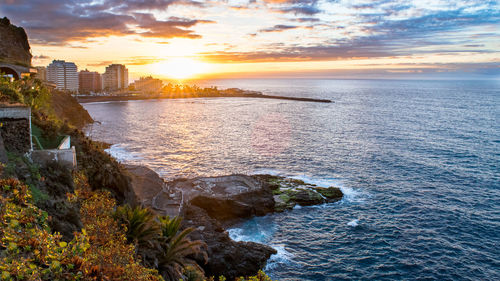 View of sea against cloudy sky during sunset