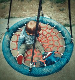 High angle view of boy on slide at playground