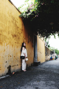 Rear view of woman walking on street