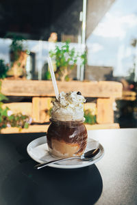 Close-up of coffee served on table at cafe