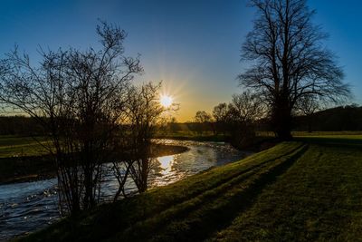 Scenic view of lake against sky during sunset