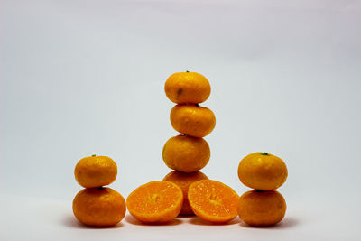 Close-up of oranges against white background