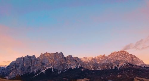 Scenic view of snowcapped mountains against sky during sunset