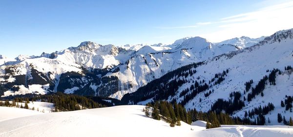 Scenic view of snow covered mountains against sky