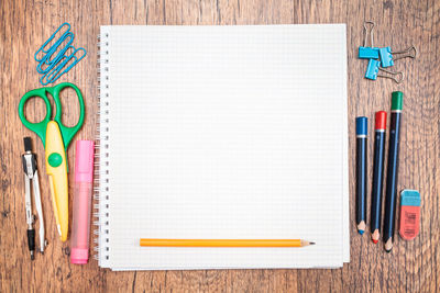 Directly above shot of school supplies on wooden table