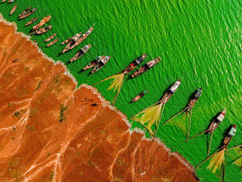 Aerial view of fishing boat moored at harbor