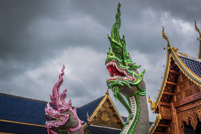 Low angle view of statue against temple building