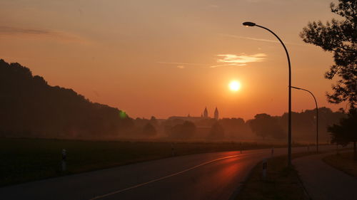 Street against sky during sunset