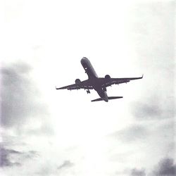 Low angle view of helicopter flying in sky