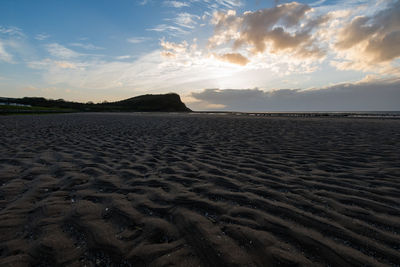 Scenic view of beach against sky during sunset