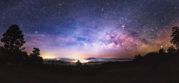 Panoramic view of landscape against sky at night