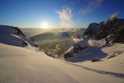 Scenic view of snow mountains against sky