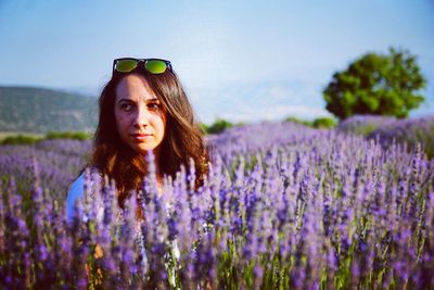 Close-up of woman looking away amidst lavender field