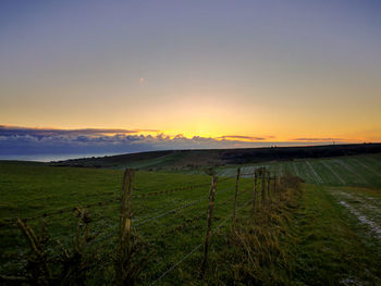 Scenic view of field against sky during sunset