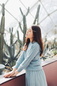 Side view of young woman standing outdoors