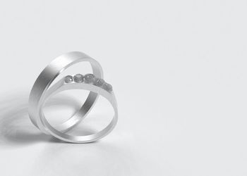 Close-up of wedding rings on white background