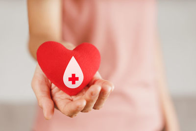 Close-up of woman holding heart shape