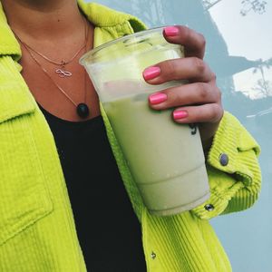 Midsection of woman holding drink