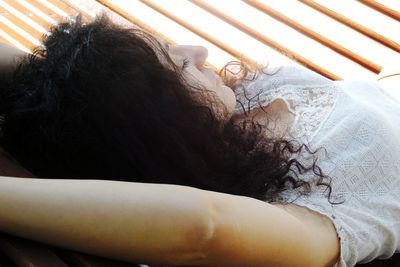 Portrait of woman lying on bed at home