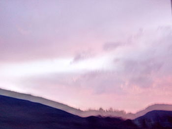 Scenic view of mountains against sky at sunset