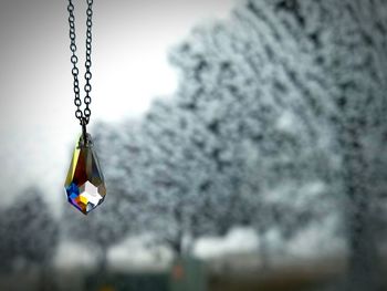 Close-up of hanging against sky