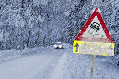 Traffic sign warns of snow and icy road