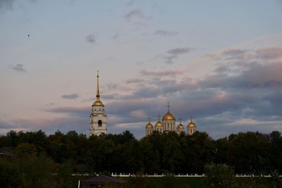 View of building and trees against sky during sunset