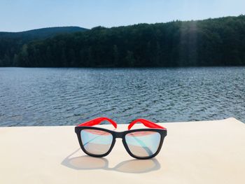 Deck chairs on beach by lake