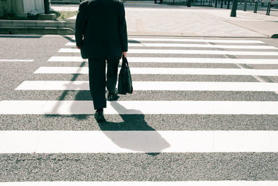 Woman walking on road