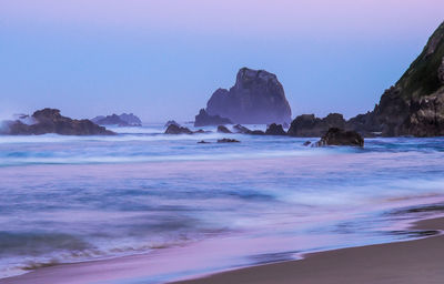 Scenic view of beach against clear sky