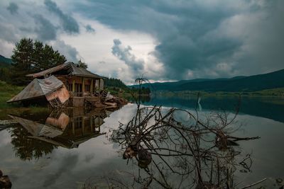 Reflection of building on lake against sky