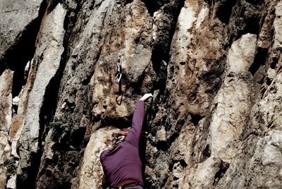 Low section of person on rock in cave