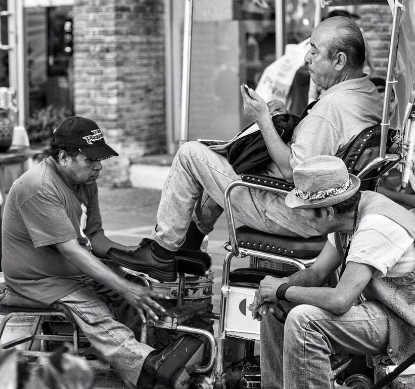 sitting, social issues, city, outdoors, cap, men, day, only men, adult, building exterior, people, adults only