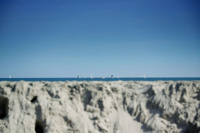 Scenic view of sea against clear blue sky