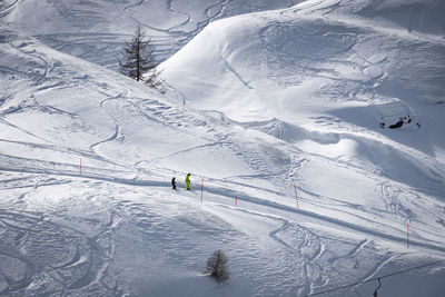 High angle view of people skiing on snowcapped mountain