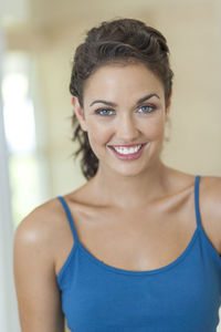 Portrait of smiling mid adult woman standing at home