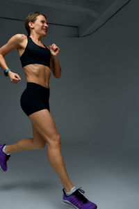 Low section of woman exercising in gym