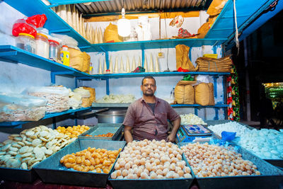 Full length of man standing at market stall