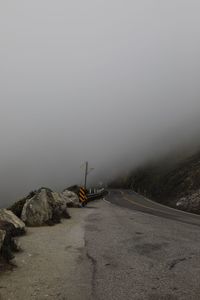 Road amidst rocks against sky